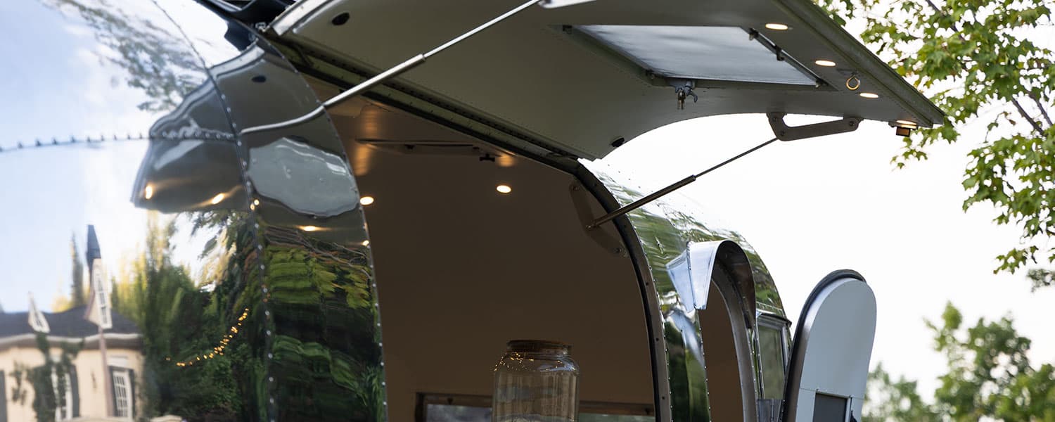 Hydraulic strut-supported hatch with integrated LED lighting on polished aluminum exterior 1959 Airstream Tradewind