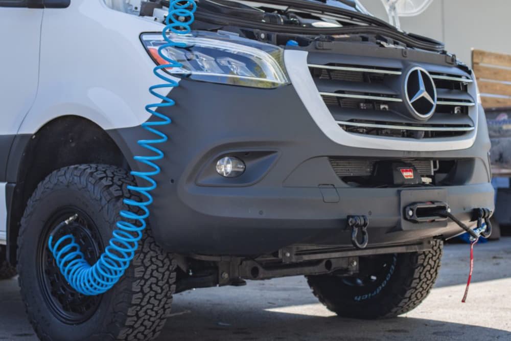 Onboard air compressor installed under a van