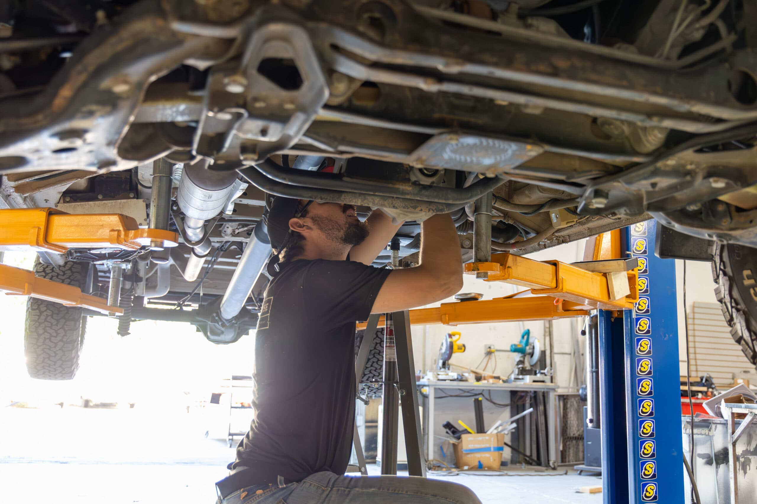 Undercarriage armor work on a lift