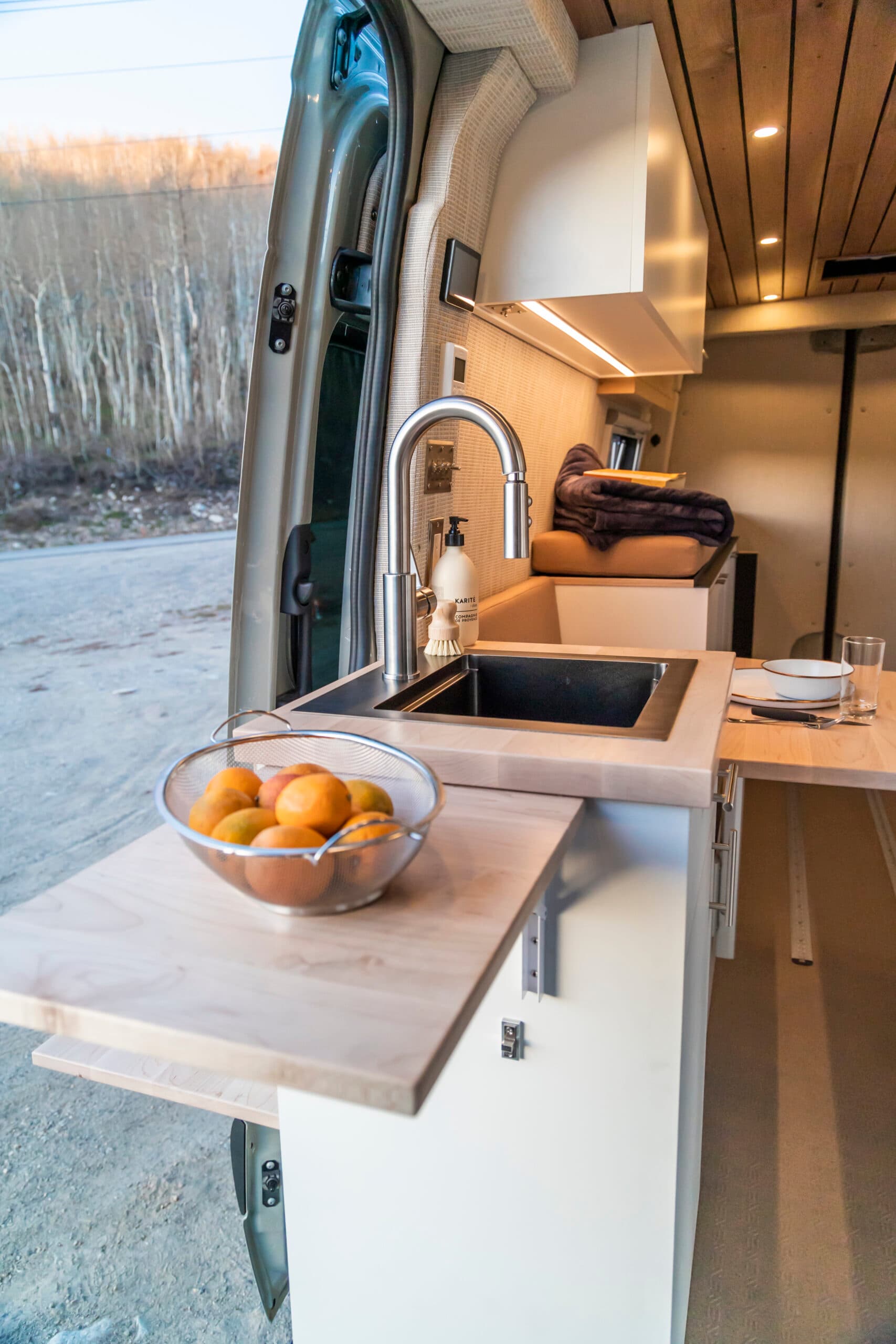 Van interior with sink and fold-out tables